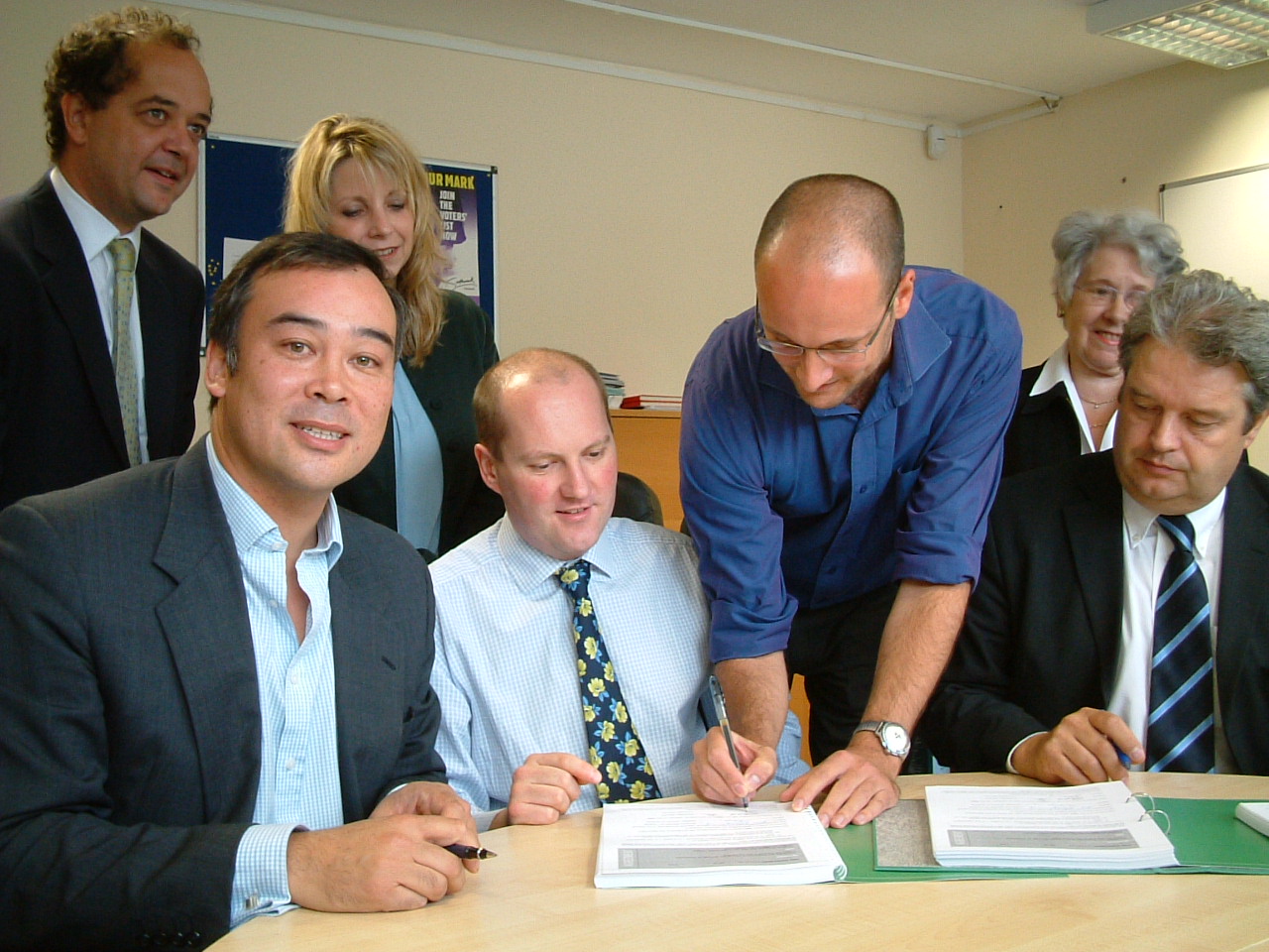 Photo of residents signing transition documents in the Estate Office